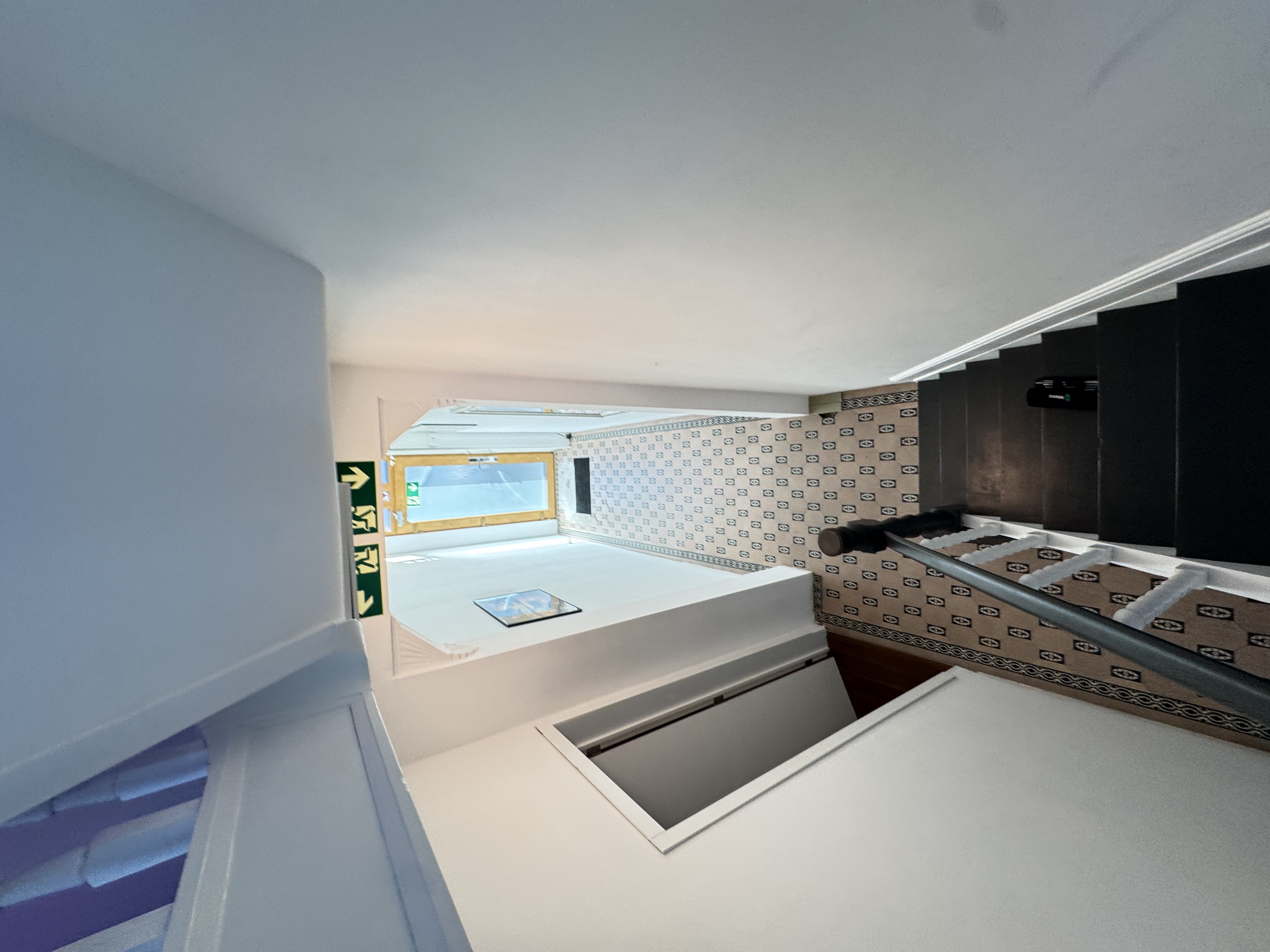 Ground floor entrance hall, signs showing main door and alternative direction.