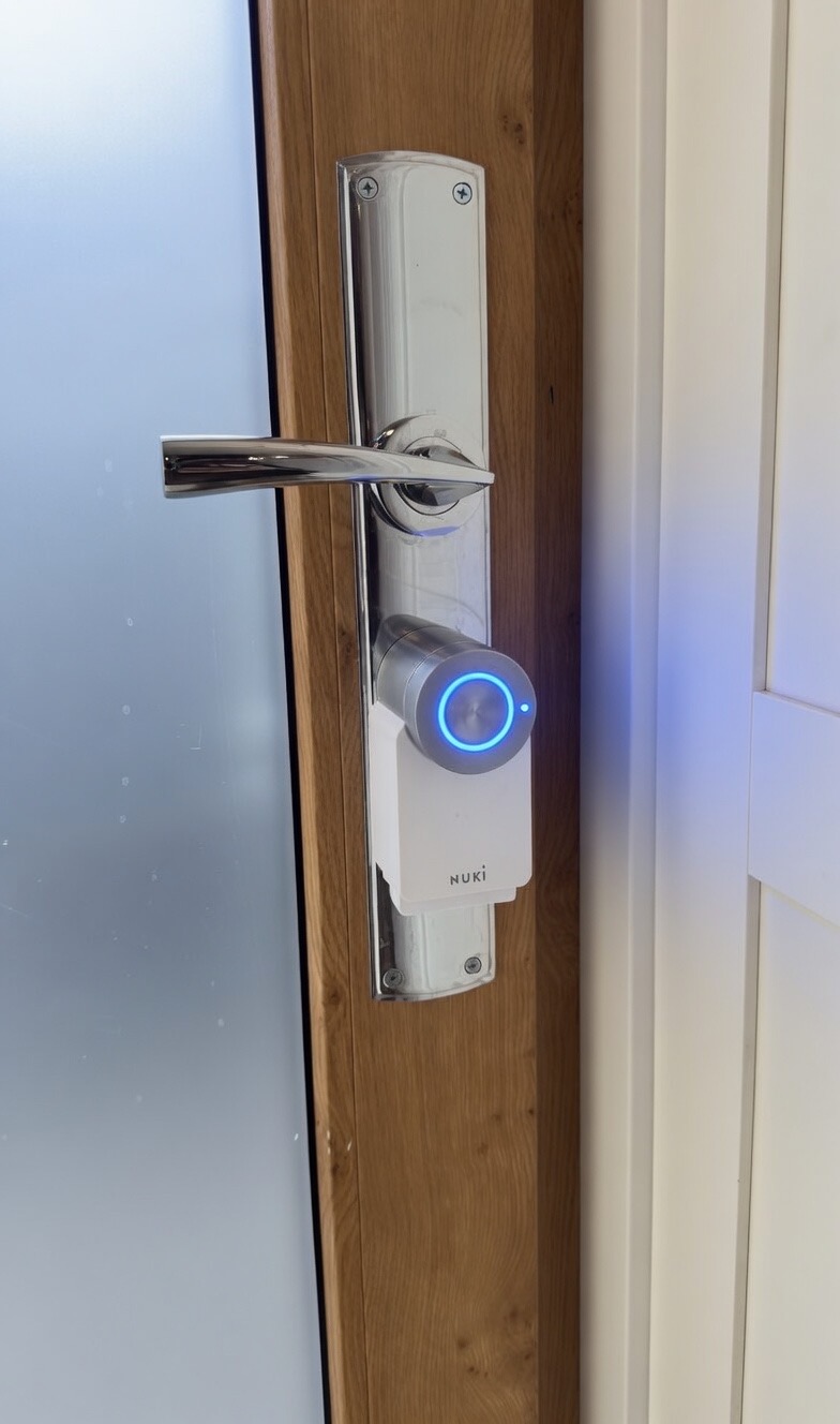 Close-up of the main door lock, centre push-button and round upper knob visible.