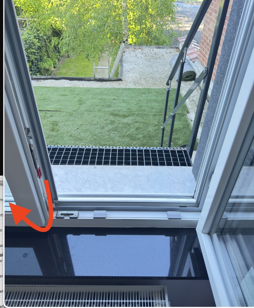 Close-up of the red centre lever that releases both window leaves.